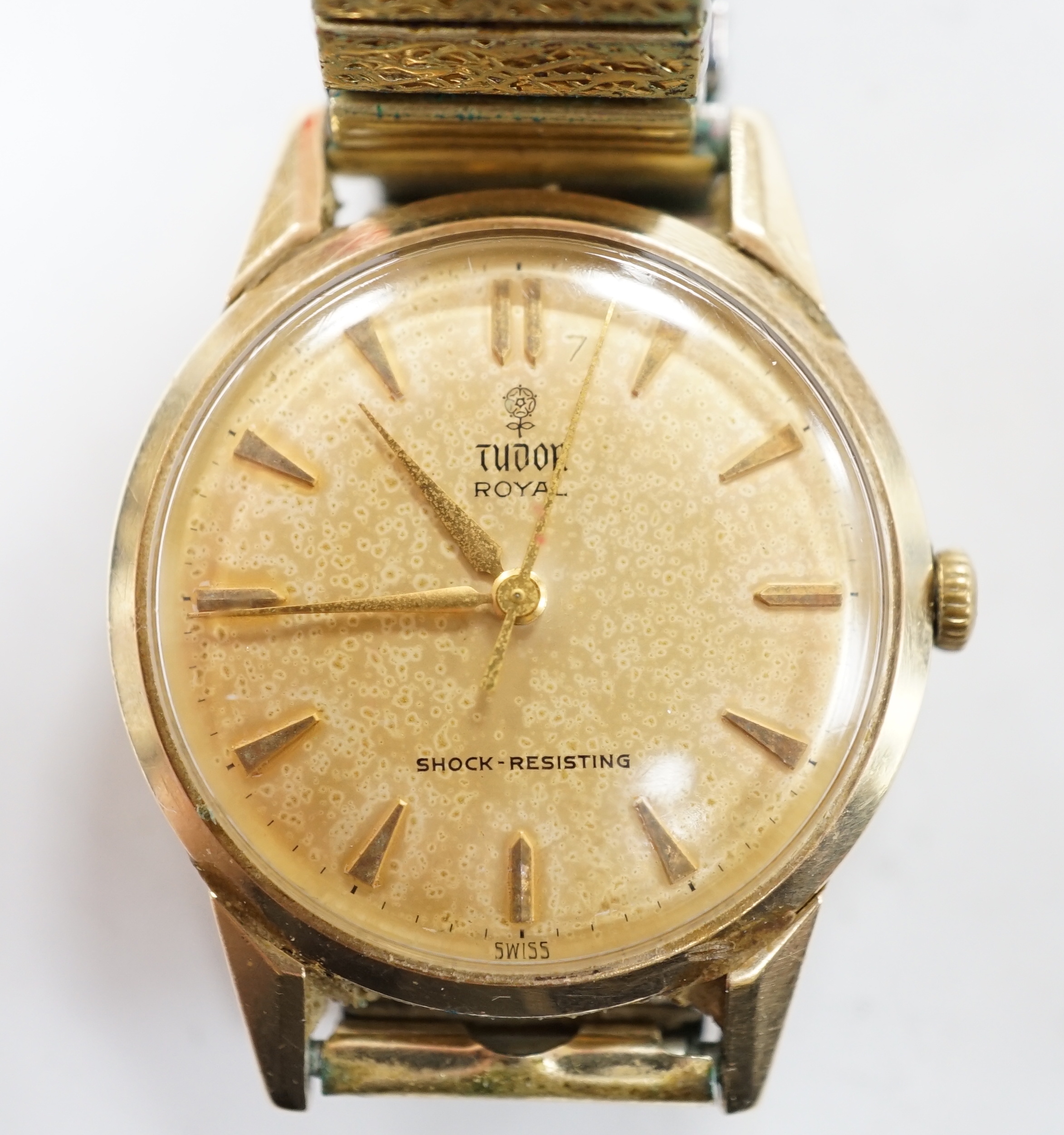 A gentleman's yellow metal Tudor Royal manual wind wrist watch, with baton numerals, on an associated flexible strap, with Tudor box.